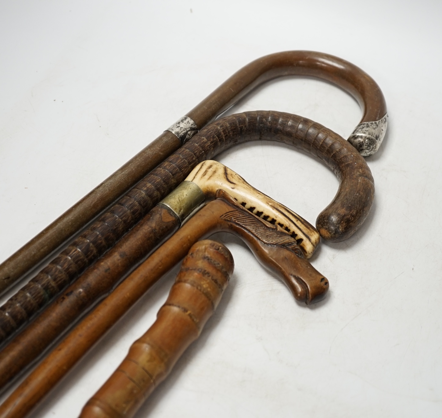 A collection of five various walking sticks/canes including silver mounted, longest 93cm. Condition fair